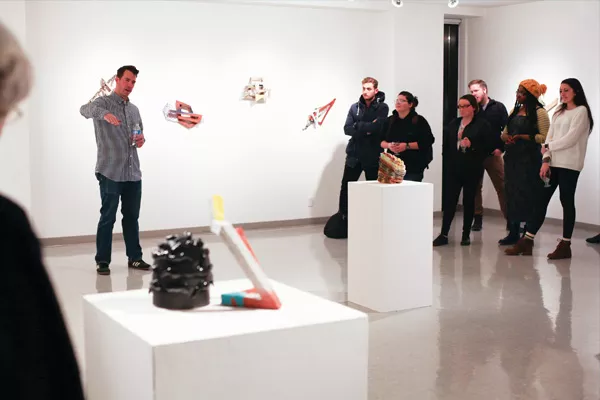 Artist Tyler Lotz addresses attendees at the “Oblique Frontiers” opening on Jan. 26. - PHOTO COURTESY UIS GALLERY