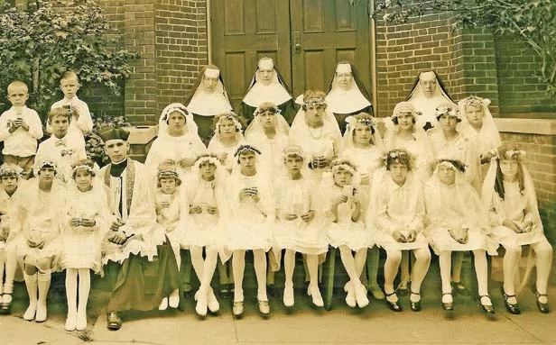 Father Stanislaus O. Yunker (seated, center) and children of St. Vincent de Paul Lithuanian Catholic Church at one of the first confirmation ceremonies held in the parish after he arrived in 1924. - PHOTO COURTESY SPRINGFIELD DIOCESE IN ILLINOIS