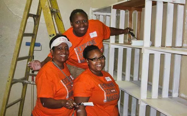 Chapter president Candice Trees, left, along with sorority members Tiffany Lott and Keneisha Boozer paint during the Harvard Park makeover.