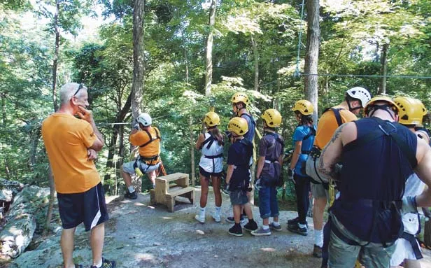 A tour group prepares to launch on one of eight zip lines of the Shawnee Bluffs Canopy Tour. - PHOTO BY ROSE HAMMITT