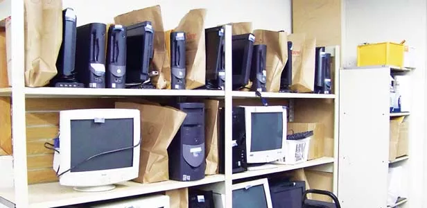 Refurbished computers, loaded with new software, ready to go to clients for $100 apiece. - PHOTO BY ERICKA HINE