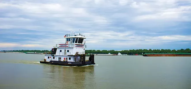 The Shawnee Forest towboat steers down the Ohio River near American Commercial Barge Line's office outside Cairo. As of June 12, there were more than 600 barges waiting to go upstream when water levels drop. - PHOTOS BY MADELYN BECK