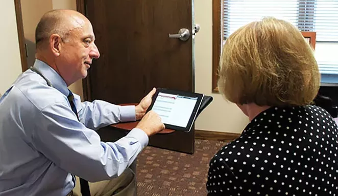 Caption: Dr. Craig Backs reviews test results with a patient at his office in Springfield. - PHOTO COURTESY CRAIG BACKS.