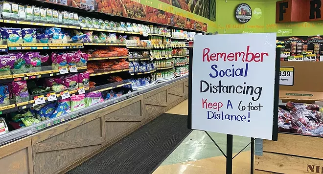 Grocery stores in Illinois should post signs reminding customers to follow social distancing rules, Gov. JB Pritzker said recently. - PHOTO BY MARY HANSEN / NPR ILLINOIS.