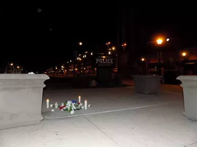 Hours after protesters departed, candles lit in memory of George Floyd outside Springfield police headquarters burned strong as dawn approached. - PHOTO BY BRUCE RUSHTON