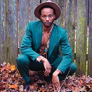 Local actor Reggie Guyton showing off a a 60s style suit, shirt and necklace purchased atSpringfield Vintage. - PHOTO BY JESSE JAEMS/MISTER SISTER PHOTOGRAPHY. MAKEUP BY EMILIE PEARL OF STUDIO STREGA.