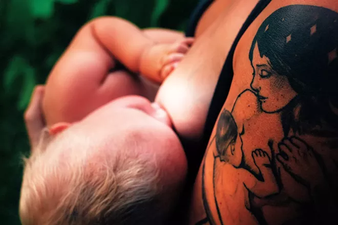Nicholle Godar is now breastfeeding her third child and got a tattoo shortly after her second baby was born as a tribute to her breastfeeding journey. She describes it as the perfect embodiment of mother and woman, saying, “It really helped me work through the identity crisis I was having still as a new mom - figuring out who the ‘new me’ was after babies.” - PHOTO BY NICHOLLE GODAR
