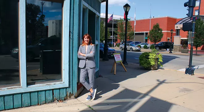Lisa Clemmons Stott, executive director of Downtown Springfield Inc., has lately been fielding lots of calls from entrepreneurs with ideas for redeveloping downtown property. Here she stands at Seventh and Adams in front of a building that was once the home of Harry S. Clayton Furniture and, more recently, Jade's Emporium. The building has been purchased by new owners with plans to convert the upper stories to 10 new apartments. - PHOTO BY JOSEPH COPLEY.