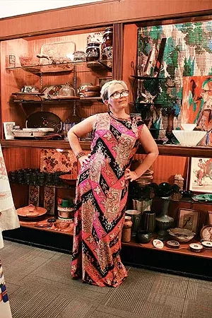 Local illustrator Carol Weems showing off a bold 70s-style print dress from Springfield Vintage. - PHOTO BY JOSEPH COPLEY. CLOTHING AND STYLE BY LINDA RENEHAN.