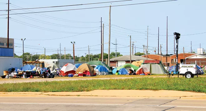Approximately 50 homeless people have created Tent City behind the city of Springfield’s Warming/Cooling Center at 1015 E. Madison St. Volunteers come every day to provide meals and supplies. - PHOTO BY BRANDON TURLEY