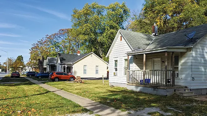 The city council has voted to buy Luann Hickman's home, yellow at center, on South Grand Avenue. - PHOTO BY BRUCE RUSHTON