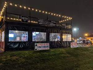 Big screen TVs were on but masks and coats were rare at the Home Plate Bar and Grill on Tuesday while customers ate and drank. - PHOTO BY BRUCE RUSHTON
