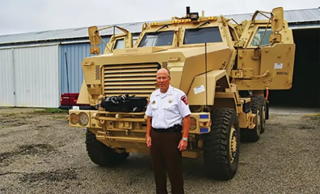 Sangamon County Sheriff Jack Campbell in 2014 with an armored vehicle that now belongs to the LaSalle County sheriff's office. - PHOTO BY BRUCE RUSHTON