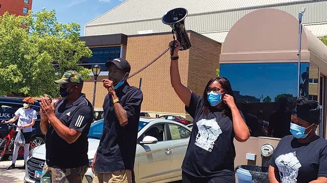 Ald. Shawn Gregory speaks before a Black Lives Matter car procession in May of 2020. Black Lives Matter Springfield co-founder Sunshine Clemons holds up a megaphone. - PHOTO BY MARY HANSEN