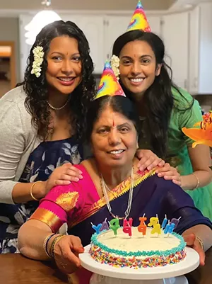 Aruna Mundlapudi, center, on her 70th birthday with her daughters, Sacharitha Bowers, left, and Sankirtana Danner, right.