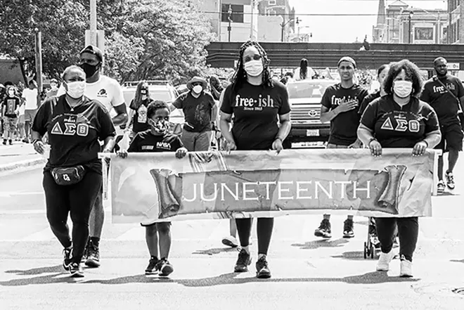 Shymeka Kerr-Gregory stands center at the head of last year's Juneteenth march to the Statehouse. - CREDIT: ZACH ADAMS, 1221 PHOTOGRAPHY