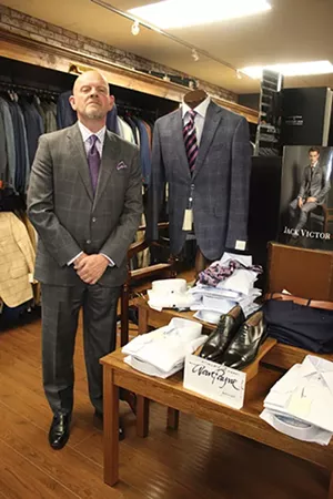 Terry Wilson, store manager at Jim Herron, Ltd., showing off his windowpane panel suit. - PHOTO BY JOSEPH COPLEY