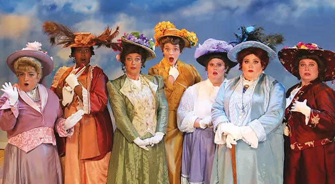 The “Pick-a-Little, Talk-a-Little” ladies dig the dish on Marian the Librarian. “She advocated dirty books – Chaucer! Rabelais! Balzac! And made brazen overtures to a man who never had a friend!” from The Legacy Theatre’s The Music Man. From L to R: Ethel Toffelmier (Missy Cartwright), Mrs. Squires (Aryanna Logan), Maude Dunlop (Betsy Buttell), Flora Merriweather (Rachel Larison), Opal Britt (Anna Benoit), The Mayor’s wife Eulalie Mackecknie Shinn (Kinsey Peotter), and Alma Hix (Allison Means). - PHOTO BY LAURA KAY COFFEY