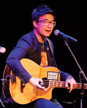 In homage to Woody Guthrie whose guitar said, “This machine kills fascists,” Tam's guitar says, “This machine kills racists.” - CREDIT: ALPLM