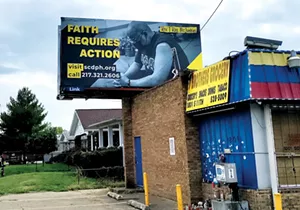 A billboard near the corner of Laurel and 11th streets features Rev. T. Ray McJunkins of Union Baptist Church and urges the community to get vaccinated. - PHOTO BY MARIA GARDNER