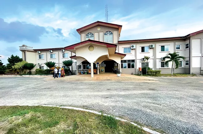(Left) International Health and Development Network’s International Mission Hospital in Ghana, 2021. Originally built as an outpatient clinic, a 100-bed inpatient hospital opened in 2013. The complex continues to expand, with staff apartments and a women’s and children’s clinic. There are now 113 staff, all from Ghana, including three doctors and 43 nurses. - PHOTO BY DR MICHAEL FENNER