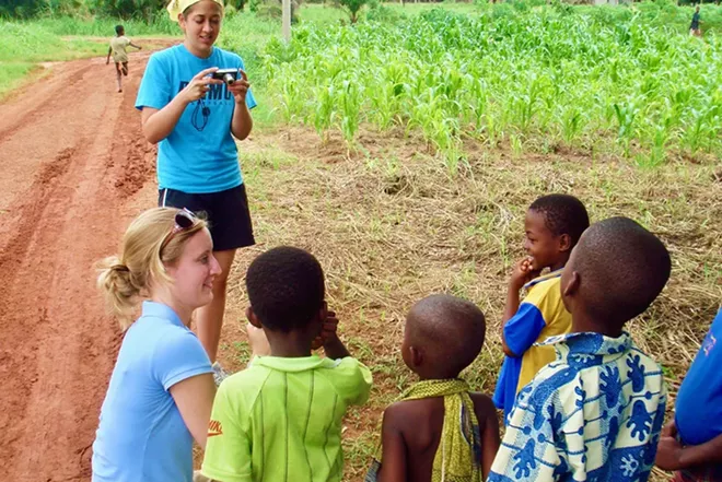 Merideth Havey, lower left, and Christi Minick, top, both from Springfield, during the 2008 mission trip, with local children. At the time Havey was a prospective medical student and Minick was an OR technician at St. John's Hospital. Dr. Merideth Havey Volle is now a pediatrics specialist at SIU School of Medicine. - PHOTO COURTESY OF DR KEITH WICHTERMAN