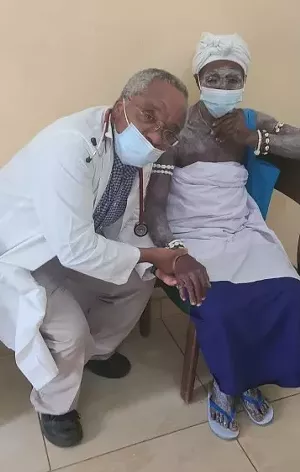 Dr. Agamah and his patient. Her skin paint reflects her participation in voodoo medicine in her village. - PHOTO BY DR. MICHAEL FENNER