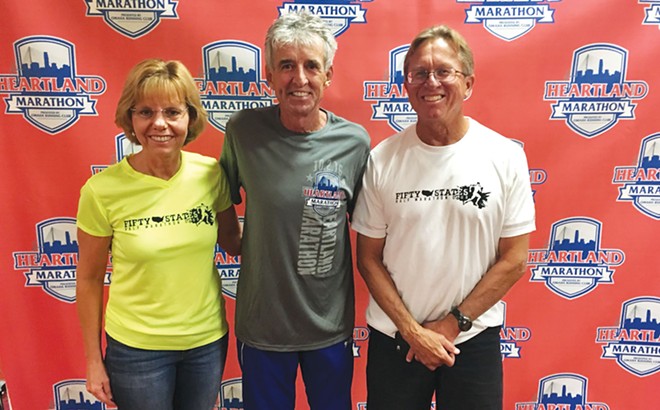 Cheryl and Joe with Frank Shorter (center) at the Heartland Half Marathon in Omaha, Nebraska, in 2016 where Shorter was the guest speaker as a supporter of local races.  Shorter won the gold medal in the marathon at the 1972 Olympics and silver medal at the 1976 Olympics. Now approaching 70, he is an attorney who campaigns against doping. Cheryl and Joe enjoyed having a 30-minute conversation with this icon of the running world. - COURTESY CHERYL AND JOE BIESIADA