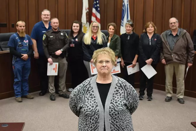 Holly Shanks stands in front of the first responders who helped to save her life on July 3. Left to right, Sam Carpenter, Jason Shumaker, Jamie Bettis, Lynne Bell, JaNece Sweeten, Aleece Ford, Gina Hamilton, Betty Stewart and Ron Lyons.