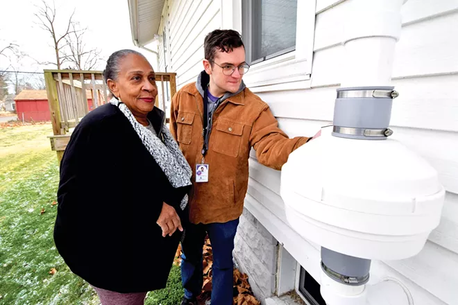 (Left) Springfield resident Zevernett Holloway and SIU Medical School's Nicholas Benning examine a radon remediation system installed on Holloway's home as part of the Access to Health Collaboration between the major health care providers in the city. - PHOTO BY DAVID BLANCHETTE