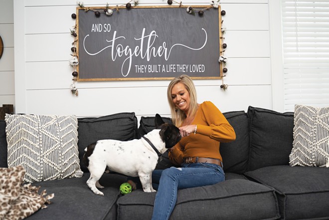 Tia Wessel with her French bulldog, Buster, at her home in Jacksonville. The 33-year-old struggled with COVID symptoms for more than a year after her initial diagnosis. - PHOTO BY JOSH CATALANO