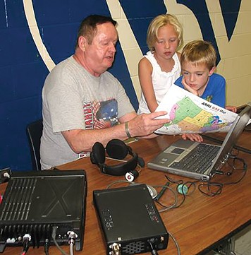 Ron Bakunas explains how a radio works to young children. - PHOTO COURTESY OF OF THE SANGAMON VALLEY RADIO CLUB