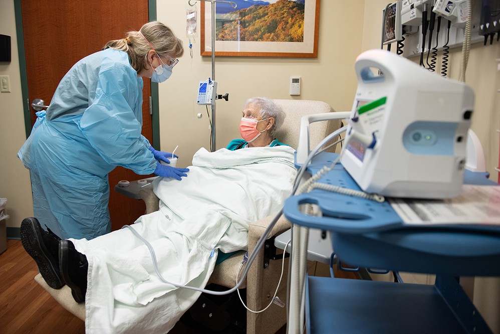Sarah Kirby receives the monoclonal antibody treatment, an infusion therapy for patients with mild to moderate symptoms of COVID-19, at Memorial Care at South Sixth while registered nurse Pam Burke oversees her care.