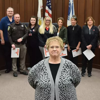 Holly Shanks stands in front of the first responders who helped to save her life on July 3. Left to right, Sam Carpenter, Jason Shumaker, Jamie Bettis, Lynne Bell, JaNece Sweeten, Aleece Ford, Gina Hamilton, Betty Stewart and Ron Lyons.