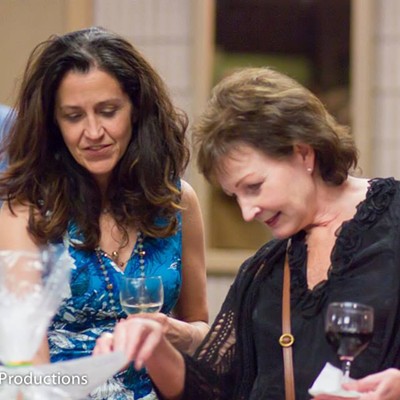 Kathy Weber and Lisa Harmon examining silent auction items