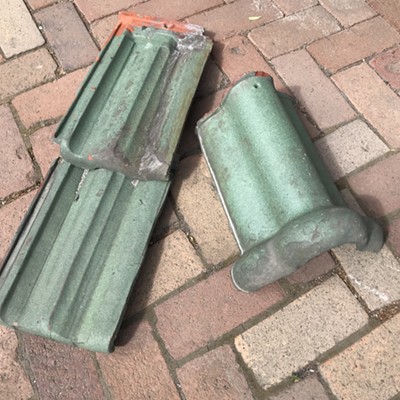 The Pullman Depot is undergoing restoration funded by a grant from Washington State Heritage Capital Project. In early June, several of the depot’s original roof tiles were discovered in hidden areas of the building – one in the attic and several more in the basement, tucked up behind a wall of the old coal chute. These original French interlocking tiles are consistent with historic photos of the building, but the color was a bit of a surprise to everyone. The original roof was green!