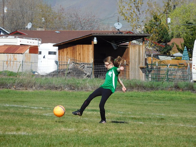 Anna kicking soccer ball