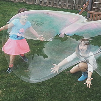 Josey, 4, and Emma, 7, at there home in the Lewiston Orchards have fun with uncle Jacob Aeling at the bubble wand. Photo was taken on Easter Sunday, 2015. Parents are Matt and Jeanette Hemphill. Photo by grandfather&nbsp;Dan Aeling.
