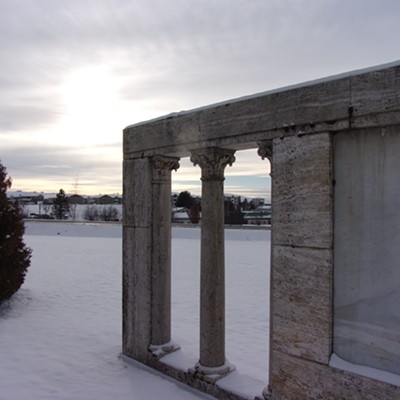 This image evokes a different era with the concrete wall at the Moscow cemetery and
in the distance, modern homes. Taken Dec. 19th.