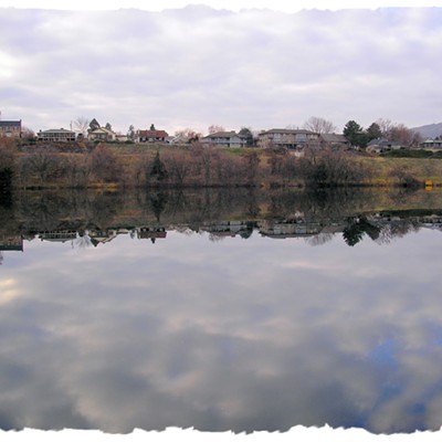 Mirror-like Snake River passing Clarkston. Photo of houses refected in the water. Taken from the Lewiston dike across from Clarkston. Taken on December 14, 2019. Taken by George Currier.