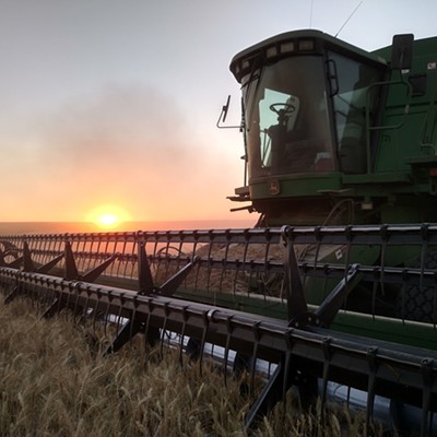 The dust settles and the sun sets on another day of harvest, south of Genesee. Photo by Chris Moser of Lewiston.