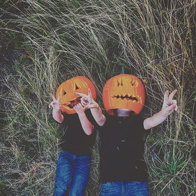 Monday October 11, Brothers Rhyett Squires (Left) Linken Squires (right) give piece signs well taking a pumpkin head picture.