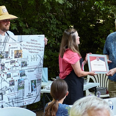 Outgoing five-term mayor of Pullman, Glenn Johnson, right, is presented with a Good Neighbor Award and a map illustrated with photos and memories at the College Hill Association's annual neighborhood barbecue June 29. CHA co-chairs Allison Munch-Rotolo, center, and Bob Cady, left, made the presentations on behalf of the group. By tradition, the Good Neighbor Award is presented to nonresidents of College Hill who make significant contributions toward improving the quality of public life in the neighborhood.