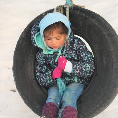 My friend Sandra's daughter, Gabby loving the tire swing in the snow