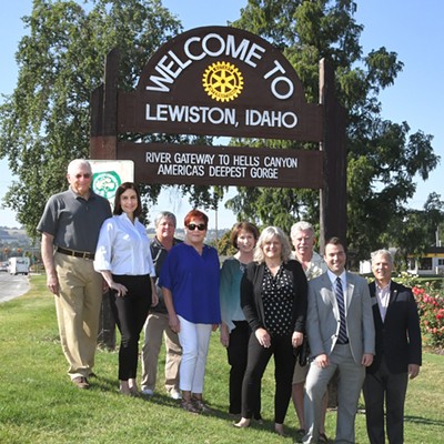 The Lewiston Rotary Club recently worked with the city on tracking down, refurbishing and installing this sign, welcoming commuters to town in north Lewiston. Pictured here from left to right is Carmine Petracca, Cari Miller, Frankie Paffile, Melva Prasil, Helen LeBoeuf, Barb Craigie, Don Brigham, Matt Weibler and John Weibler. Photo by Barry Kough, taken July 20, 2018, in the Rose Garden in north Lewiston.
