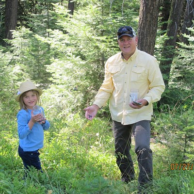 Maya and her father David Pankey of Lewiston, picking huckleberries on Craig Mountain