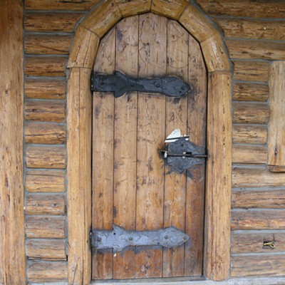 The front door of the closed small log mill in culdesac looks to be made of the logs that were milled thre. well done and good advertising but locked now. taken dec 1.