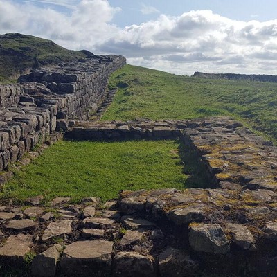This was taken along the Hadrian's Wall Path in northern England, built by the Emperor Hadrian in 122 A.D. Besides long sections of the wall, there are remains of the turrets and also the soldiers' barracks (called "Milecastles"). It's an incredible experience to be so close to this engineering marvel, almost 2,000 years old! Photo was taken by Virginia McConnell in September 2017, near Once Brewed, England.