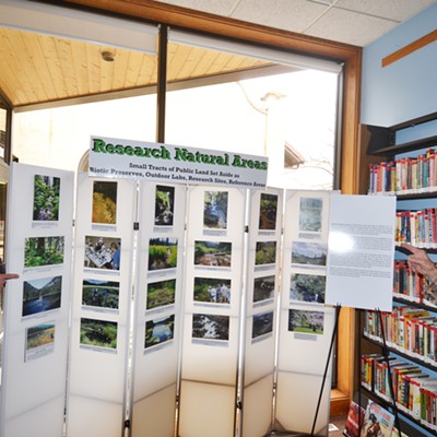 Moscow's Brett Haverstick, left, and Fred Rabe with Friends of the Clearwater stand next to the new interpretive panel at the Moscow Library. The panel includes information about Research Natural Areas.