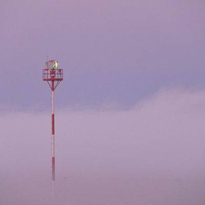 Rotating beacon rising above the fog